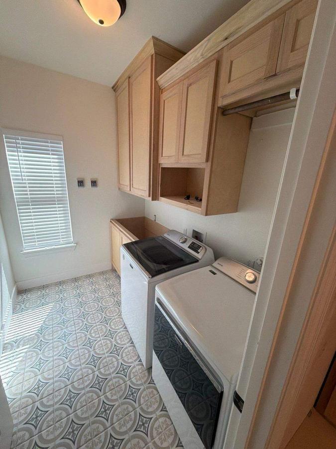 Laundry room with patterned tile floor